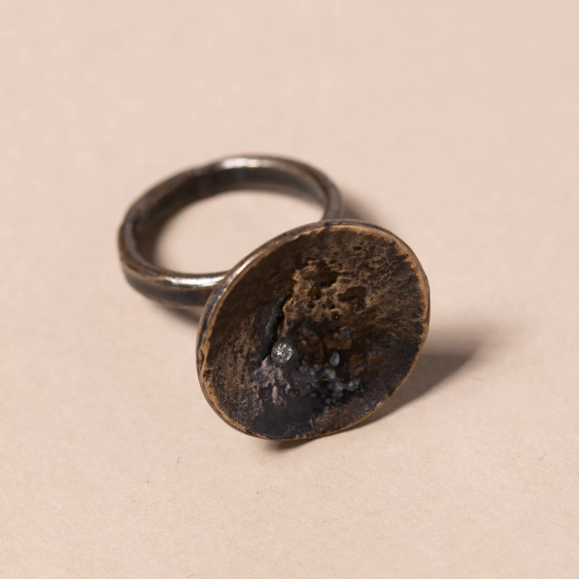 Large Bronze Disk with Diamond Ring